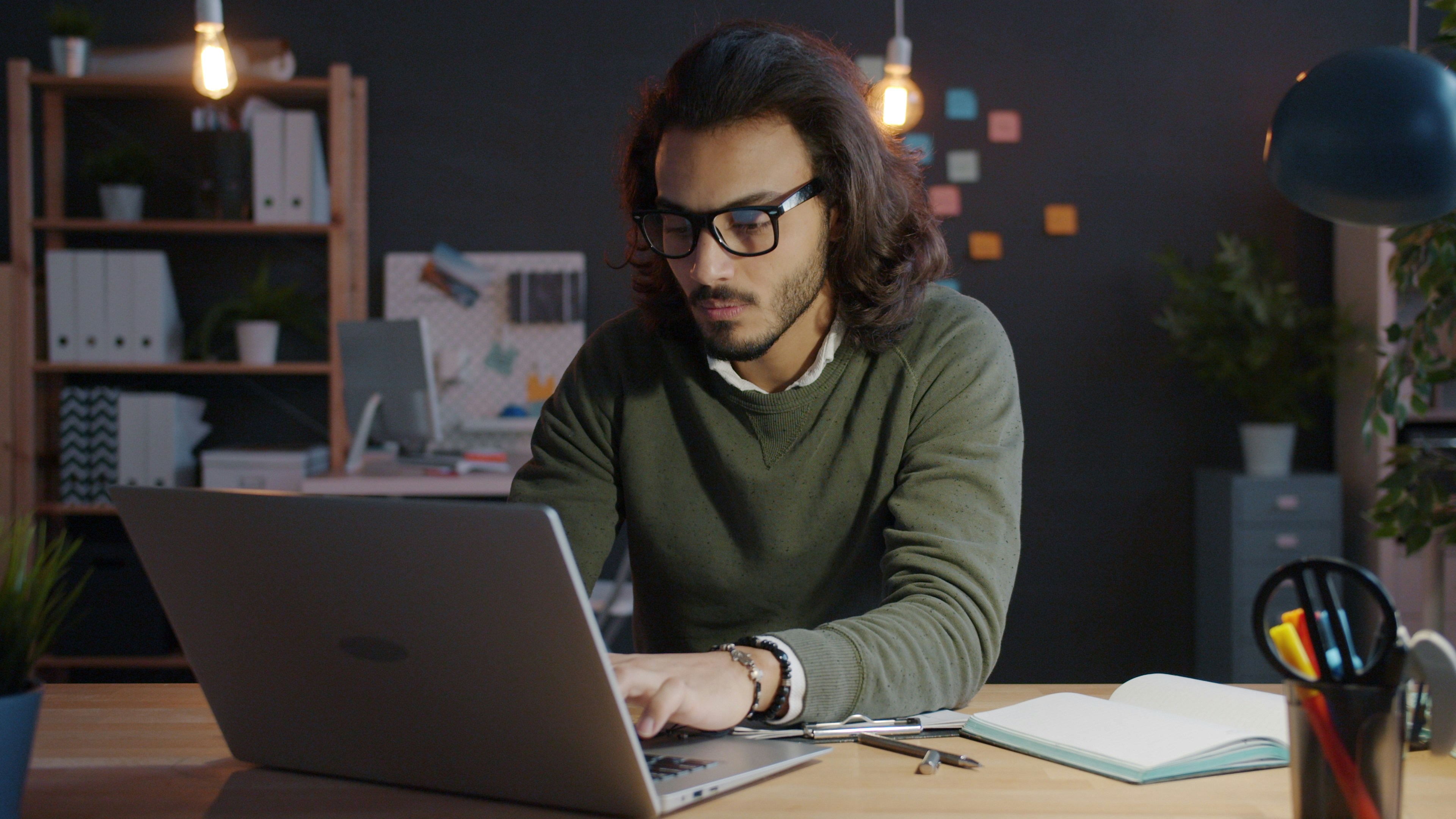Person working on a laptop in a focused workspace